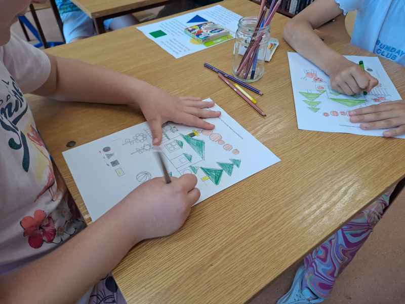 zdjęcie dzieci podczas kolorowania geometrycznego obrazka