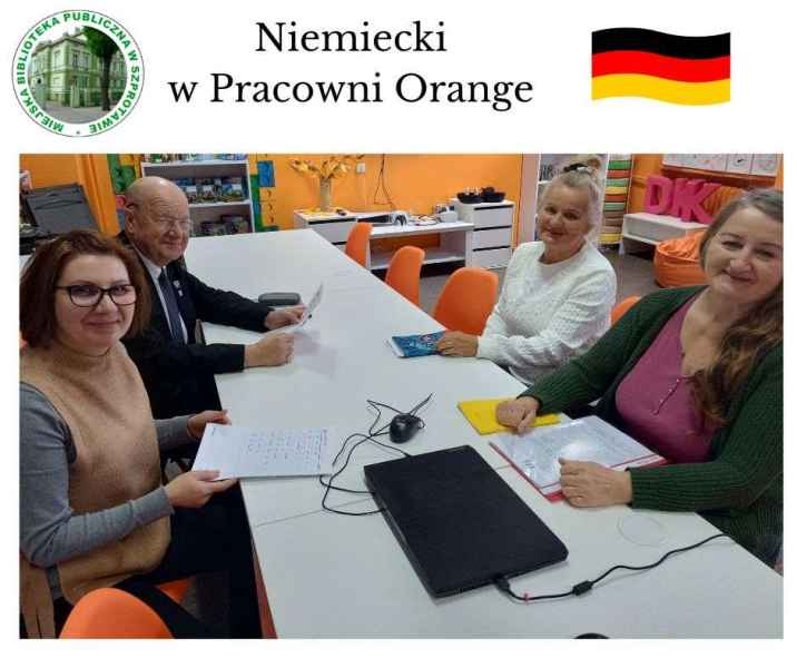 zdjęcie bibliotekarki i czytelników przy stoliku, na górze napis niemiecki w pracowni orange, po lewej logo biblioteki, po prawej flaga niemiec